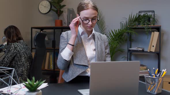 Young Business Woman Freelancer Concentrated Developing New Project While Looking on Laptop Screen alt