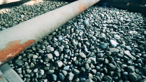 Plenty of Crushed Minerals are Falling From the Factory Conveyor alt