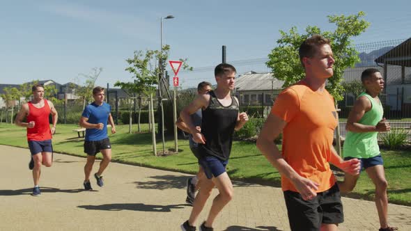 Men running outside on sunny day alt