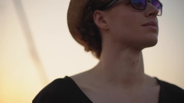 Stylish White Teenager Wearing Glasses Boater Hat Smiles at Camera alt