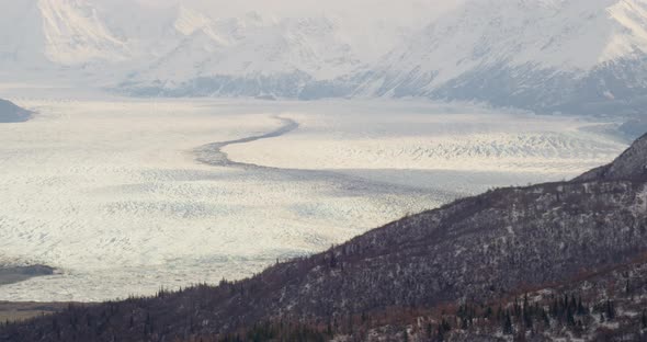 Aerial footage over snowy Alaskan mountaintops, drone helicopter footage