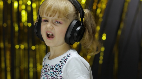 Child Dances, Sings, Listens Music on Headphones. Little Kid Girl Having Hun, Relaxing and Enjoying alt