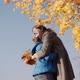 Happy Family Plays with Bouquet of Yellow Leaves in Autumn Park - VideoHive Item for Sale