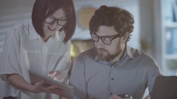 Colleagues Smiling for Camera in Dark Office alt