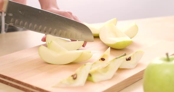 Cutting apple on wooden board alt