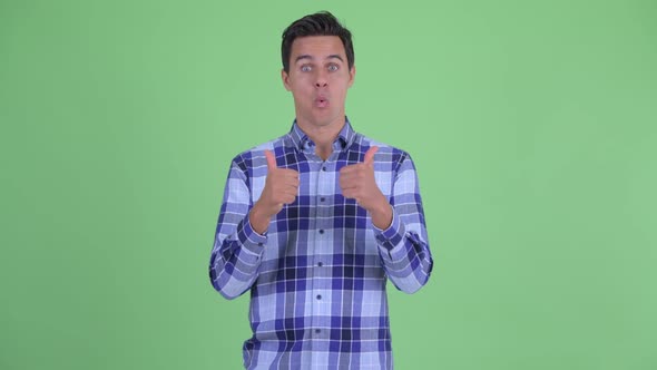 Happy Young Handsome Hipster Man Giving Thumbs Up and Looking Excited alt