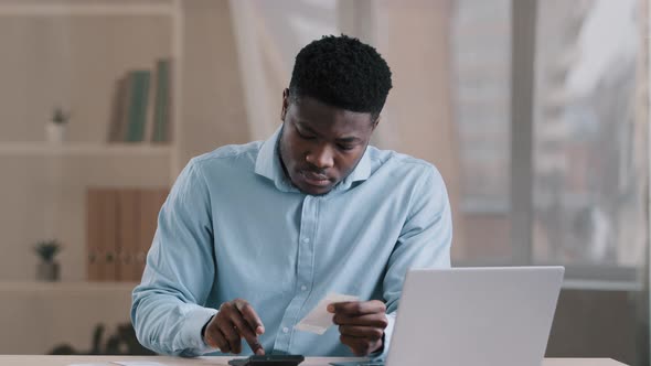 Young African Focused Man Bank Employee Bookkeeper Hold Payment Bill Manage Personal Budget Use alt