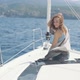 Beautiful Woman on a Yacht Enjoys the Journey on the Background of the Islands of Ibiza or Mallorca