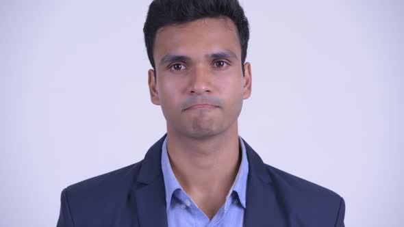 Face of Happy Young Indian Businessman Nodding Head Yes alt