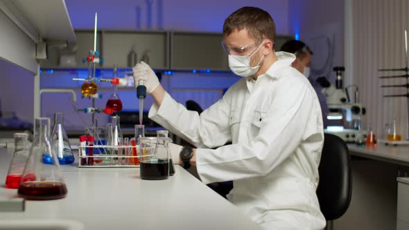 Young Scientist Mixing Colored Liquids