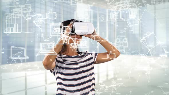 Woman using virtual reality headset with digitally generated business icons alt
