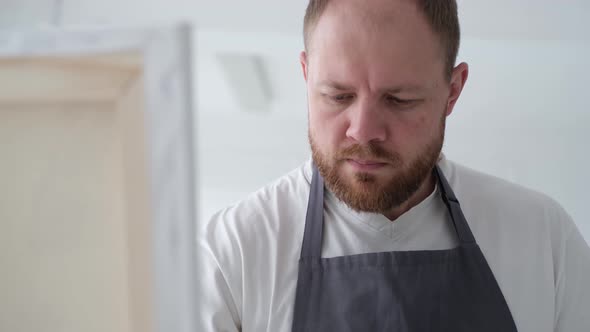 The Young Talented Artist Paints on a Large White Canvas Creates a Colorful Tangible Oil Painting alt