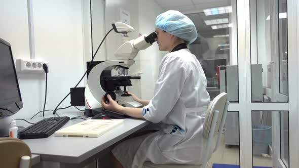 Young Researcher Using Microscope
