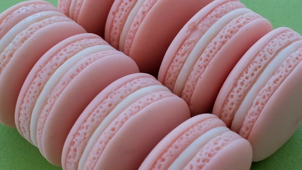 Macarons Rotating On Green Background