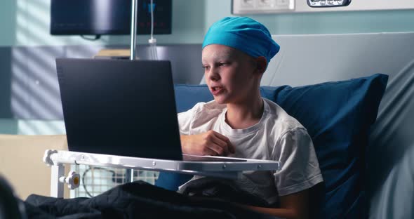 Little Cancer Patient Making Video Call in Clinic alt