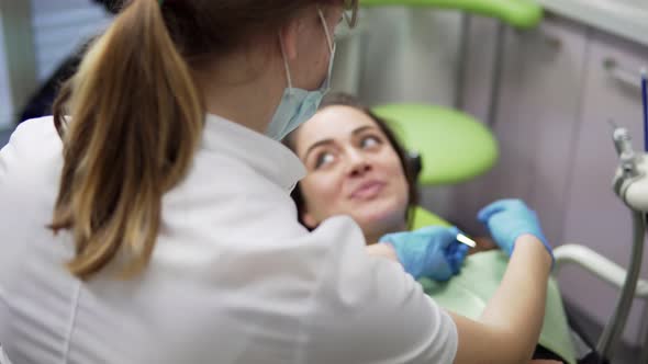 Young Female Doctor Taking on a Napkin for Her Patient alt