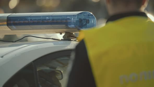 Flashing Flasher on the Roof of a Police Car. Blinker. Close-up. alt