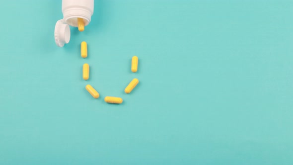 yellow pills of same color lie on a blue background.
