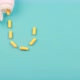 yellow pills of same color lie on a blue background. - VideoHive Item for Sale