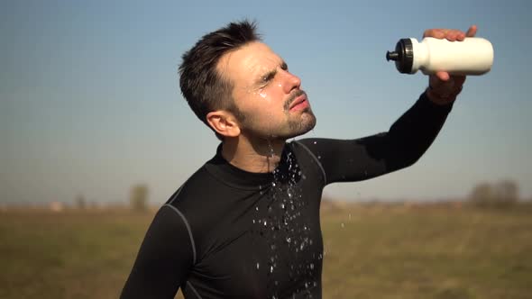 Athlete Cooling Down After Jogging Training On Trail.Tired Triathlete Jogger Relaxing After Workout. alt