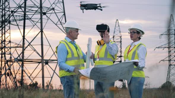 Power Engineers Are Exploring a Project with VR-glasses and a Drone alt
