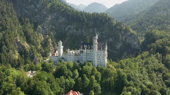 Panoramic View of Neuschwanstein Castle and Rocky Alps Mountains on the Background alt