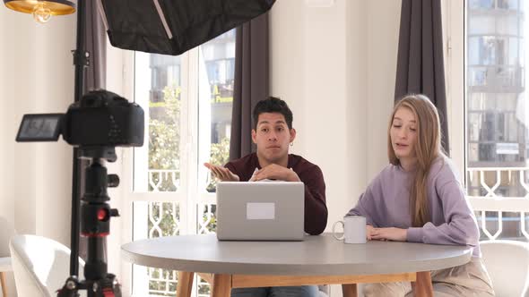 video bloggers making a video with a professional camera on a tripod at home. alt