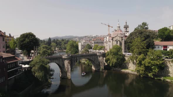 Sao Goncalo Bridge over Tamega River and beautiful church, Amarante, Portugal. Aerial view alt