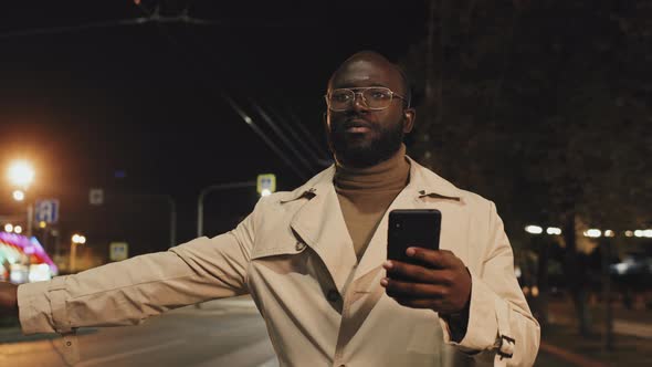 Man Catching Taxi at Night alt