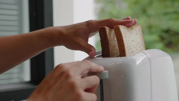 Female Hands Putting Bread Into Toaster Stock Footage Videohive