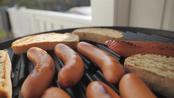 The Brown Color Frankfurter and Toast Bread on the Grill Pan