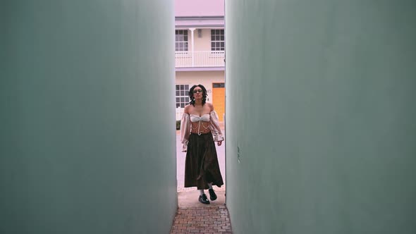 Woman Walking Down Tiny Passage