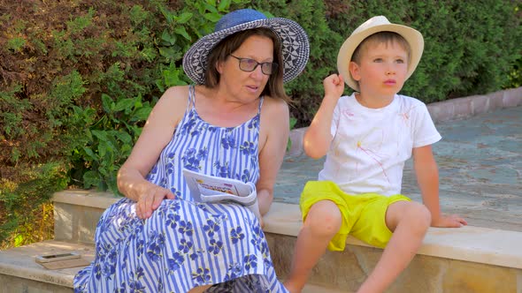 Grandmother Helps Grandson with Homework. Child Do Extracurricular Activities with Grandma. Tutoring alt