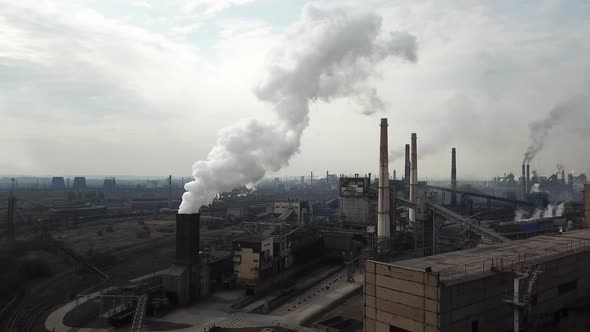 metallurgical plant production industry aerial view chimney smoke from from factorium. alt