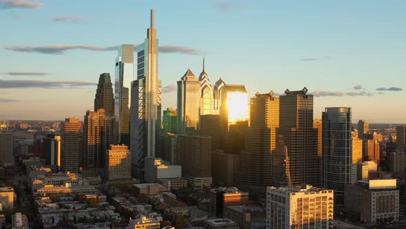 Aerial drone pull away view of the downtown Philadelphia skyline featuring tall, glass skyscrapers a alt