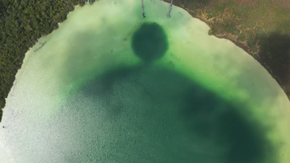 Aerial Birds Eye Overhead Top Down Panning View of Beautiful Green Lake Used As Natural Swimming alt