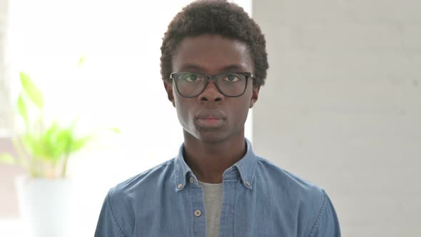 Portrait of Young African Man Looking at the Camera alt