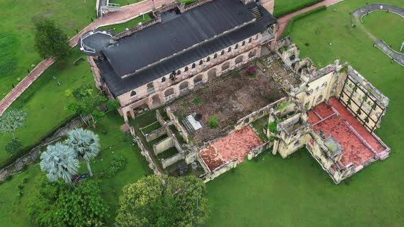 Birds eye view tilt up reveals the historic riverside Kellie's castle, capturing the backyard and un alt