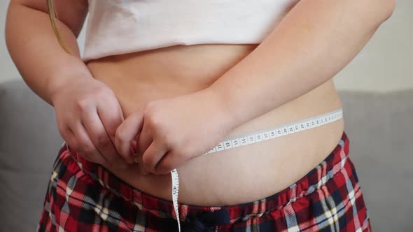 Overweight, Fat Girl Measuring Her Stomach