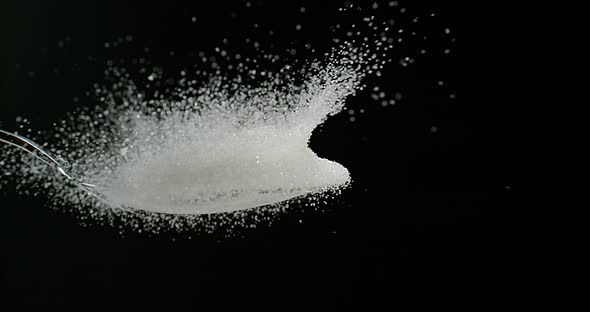 White Sugar Cube falling on Powder Sugar against Black Background, Slow Motion 4K alt