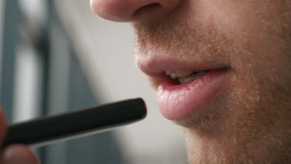 Smiling young man recording voice recognition message on speakerphone. Businessman using virtual ass alt