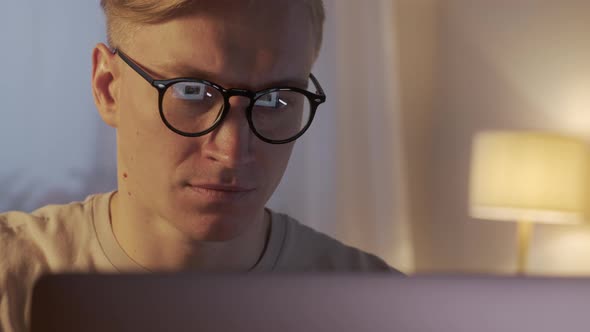 Young Caucasian Freelancer Man Working on Computer at Home at Night alt
