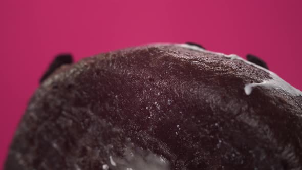 Macro Footage of a Gorgeous Donut Brown Bread. Sweets Close-up with White Cream and Pieces of Dark alt