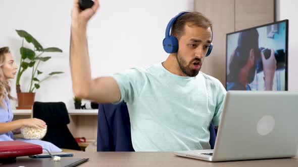 Man Games Noisily on the Computer While His Girlfriend Tries To Watch a Show on TV alt