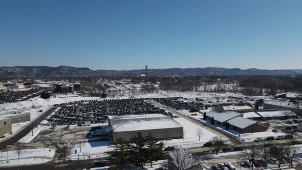 Aerial landscape view of snow covered valley with bright blue sky on a cold winter day.