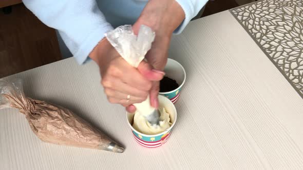 A Woman Makes Ice Cream With Cream And Biscuit Crumbs. alt
