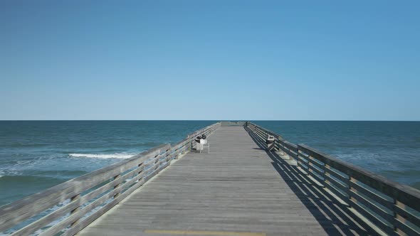 Beautiful symmetrical tracking shot of Crystal Pier, Wrightsville Beach North Carolina alt