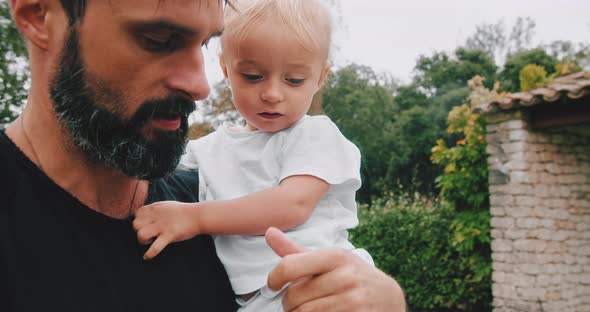 Young Father Holding in Hands His Cute Little Son alt