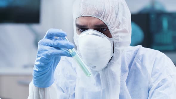 In Modern Research Facility Scientist Is Looking at a Green Sample alt