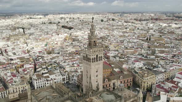 Breathtaking panoramic view of Seville cathedral bell tower and cityscape, Spain. Aerial circling